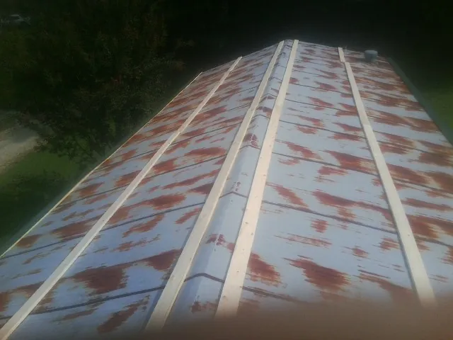 Rusted metal roof panels with new wood purlins before replacement — Storm Damage Roof Repair in Flemingsburg by Roofing Brothers