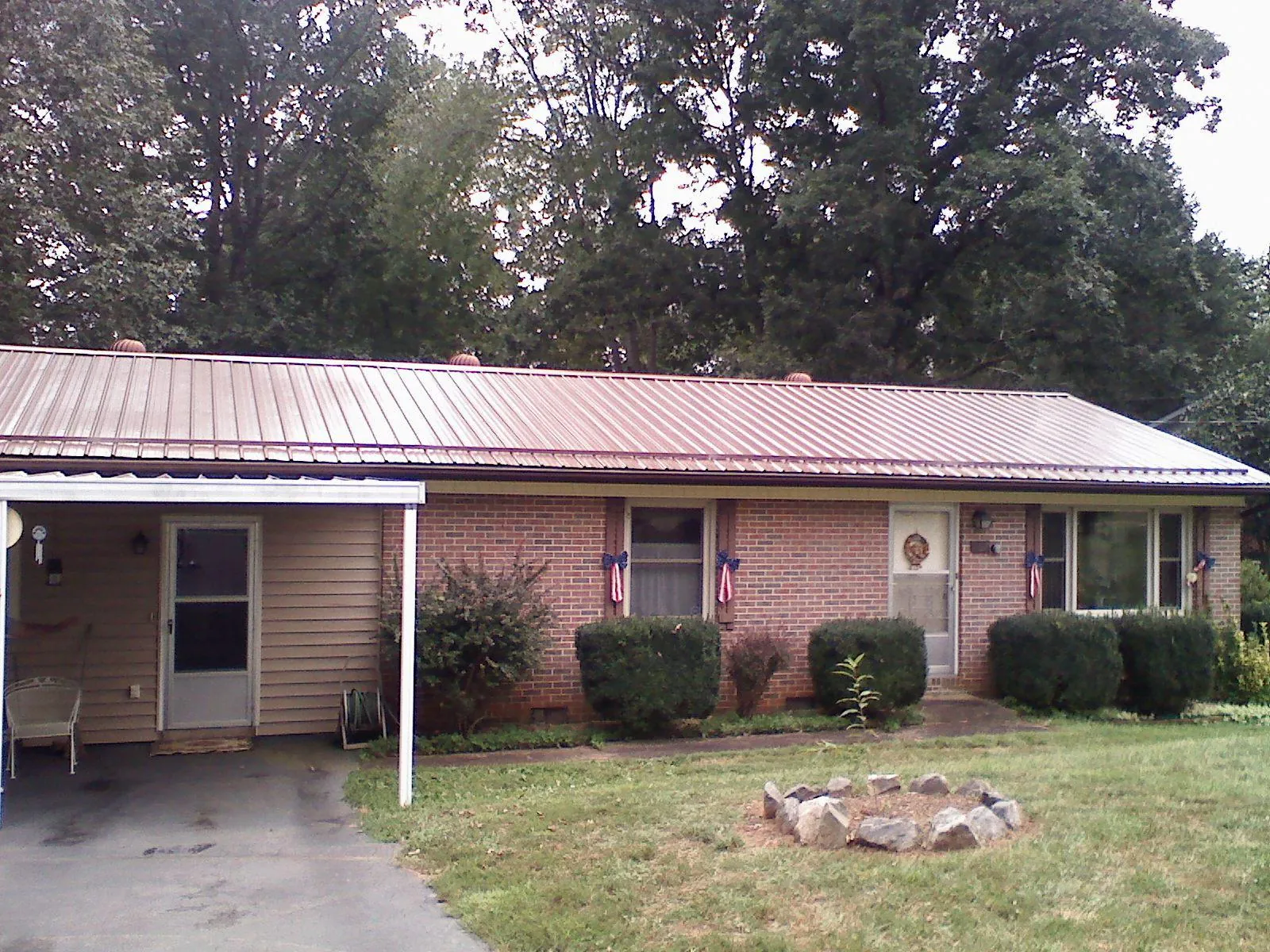 Bronze metal roof and carport on a brick ranch home — Roof Repair work by our crew in Flemingsburg